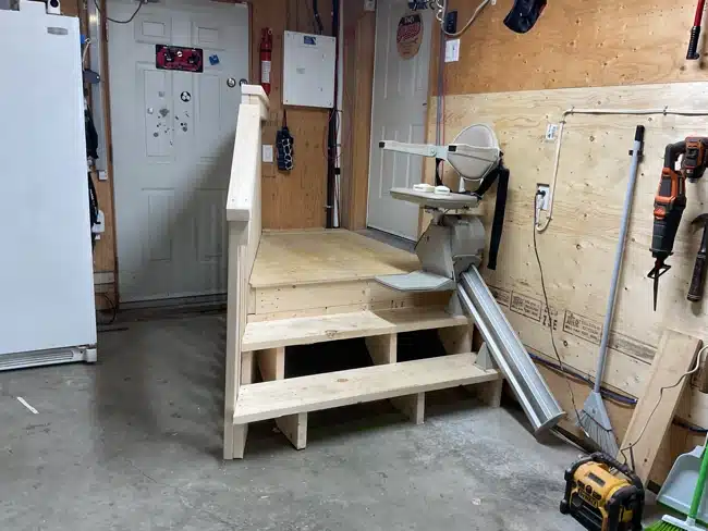 Stairlift  in garage with rail system and new steps